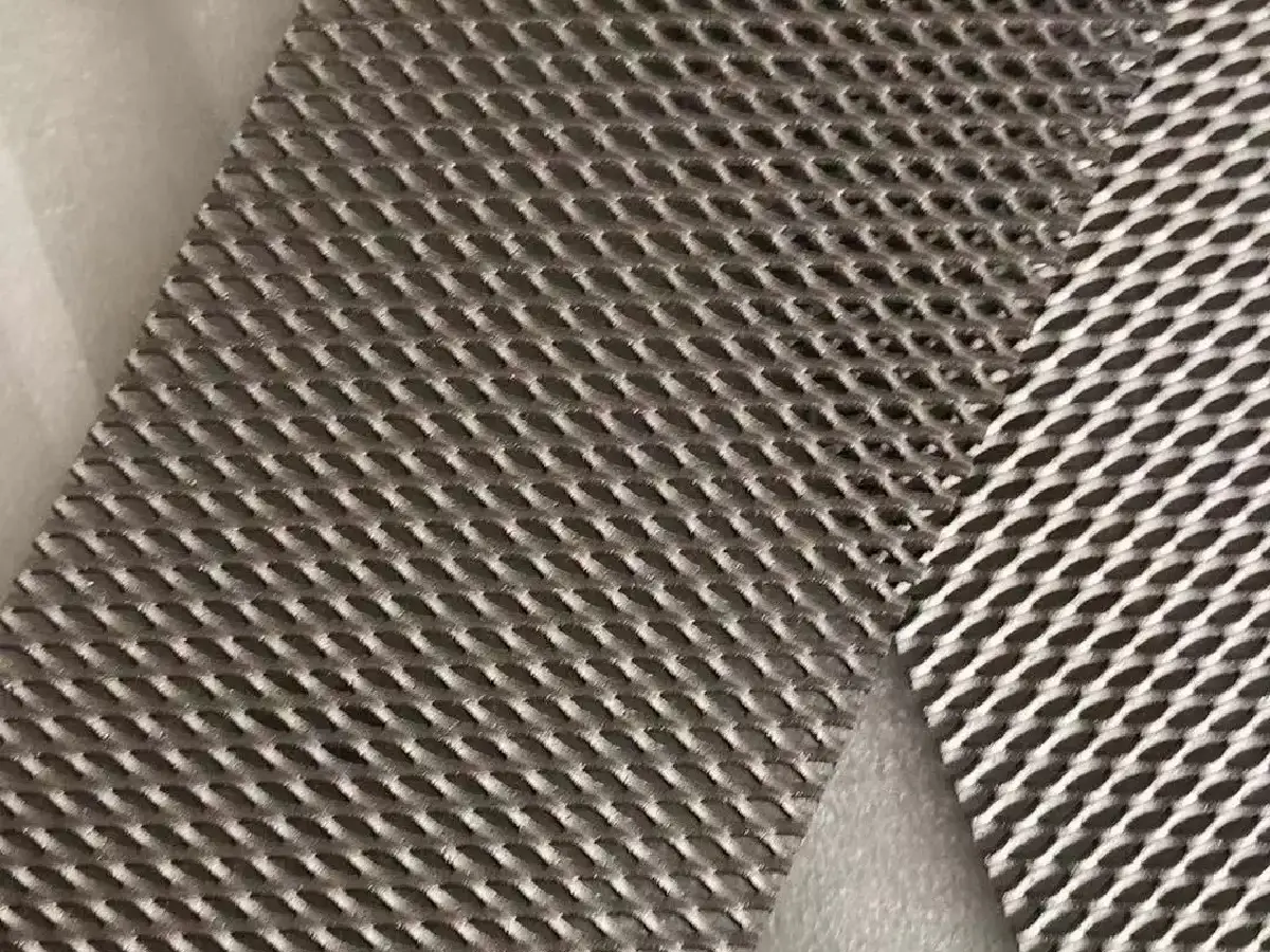 Expanded titanium mesh substrate with diamond-shaped openings; coating not identified